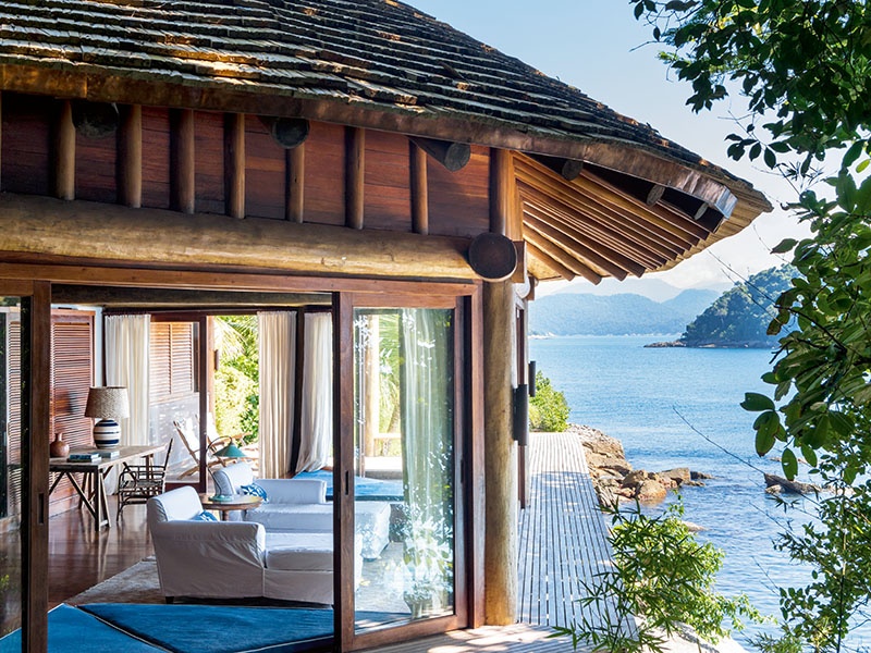 The master suite (above) has circular windows facing onto the ocean and has a stairway leading to the water's edge.