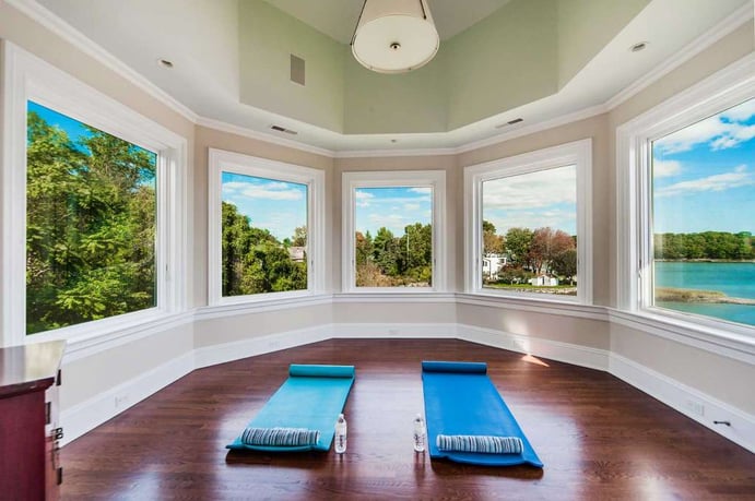 The yoga room’s panoramic shoreline view is one of many Long Island Sound exposures afforded by this elegant coastal mansion.