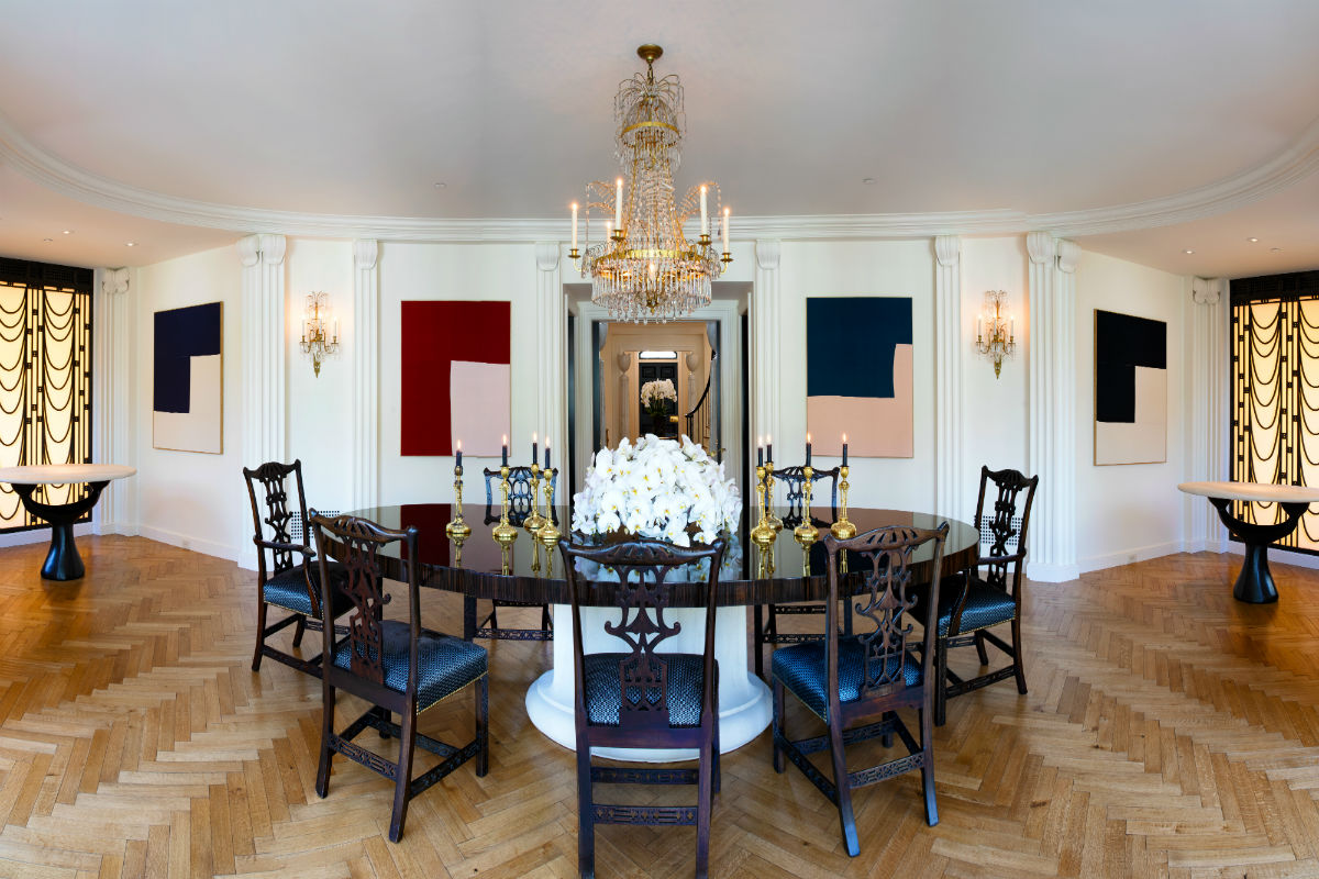 The spacious dining room displays classical and Art Deco influences and seats up to 24.