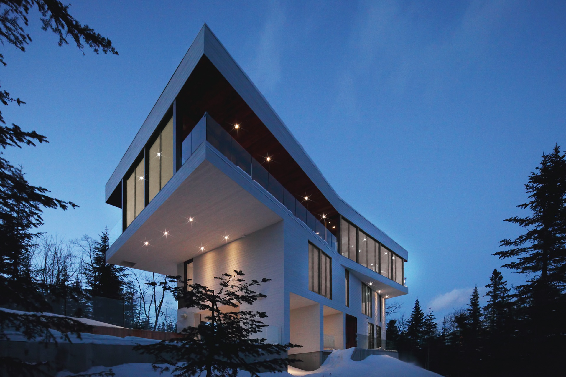 Perched on a promontory overlooking the St. Lawrence River, in Charlevoix, Quebec, this deftly designed home redefines the ski chalet for the 21st century.