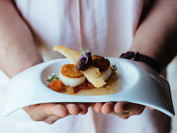 On an island with a centuries-old fishing culture—not to mention a French-trained executive chef—the seafood, such as this exquisite dish of Seared Scallops, is exceptional. Photograph: Saki Papadopoulos