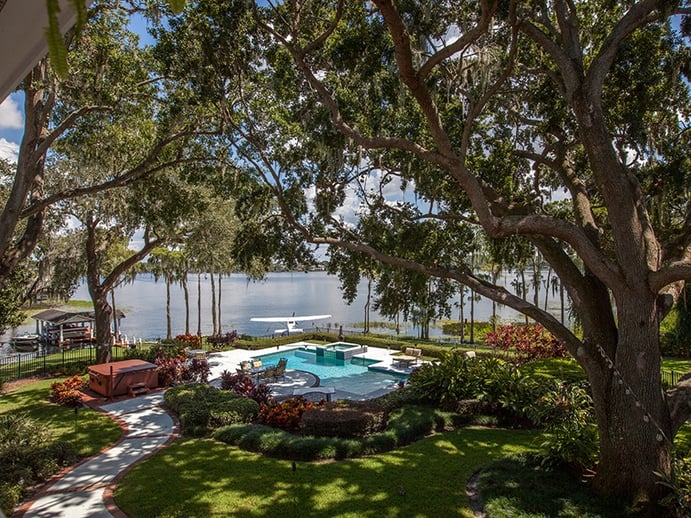 In addition to a heated pool and spa in the spacious backyard, the property has a boat dock with lift on the lake. Photograph: Regal Real Estate Professionals