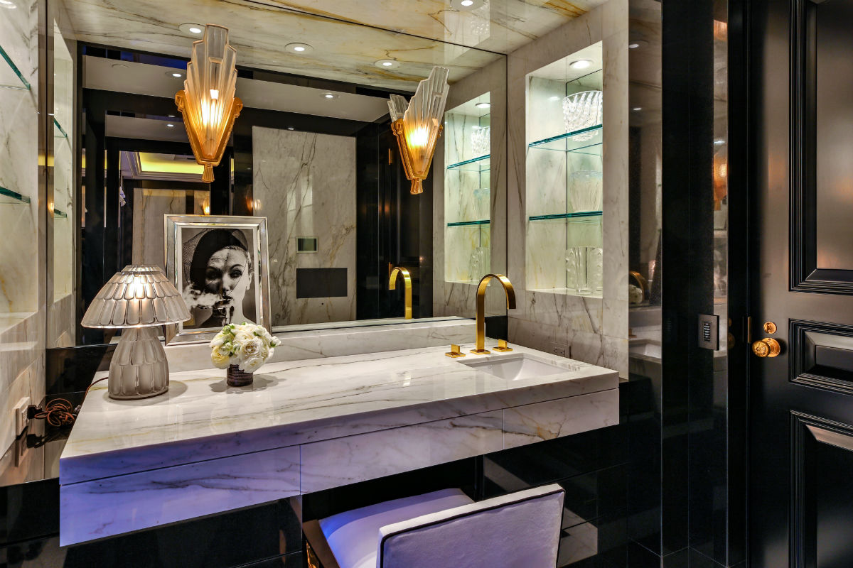 A lavish master bath is resplendent with marble and granite surfaces as well as recessed lighting.