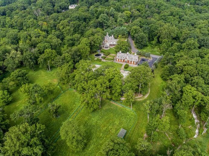 This riverfront estate’s outstanding amenities include a nine-stall barn, jumping area, paddocks, and riding trails along New Jersey’s Ramapo River.